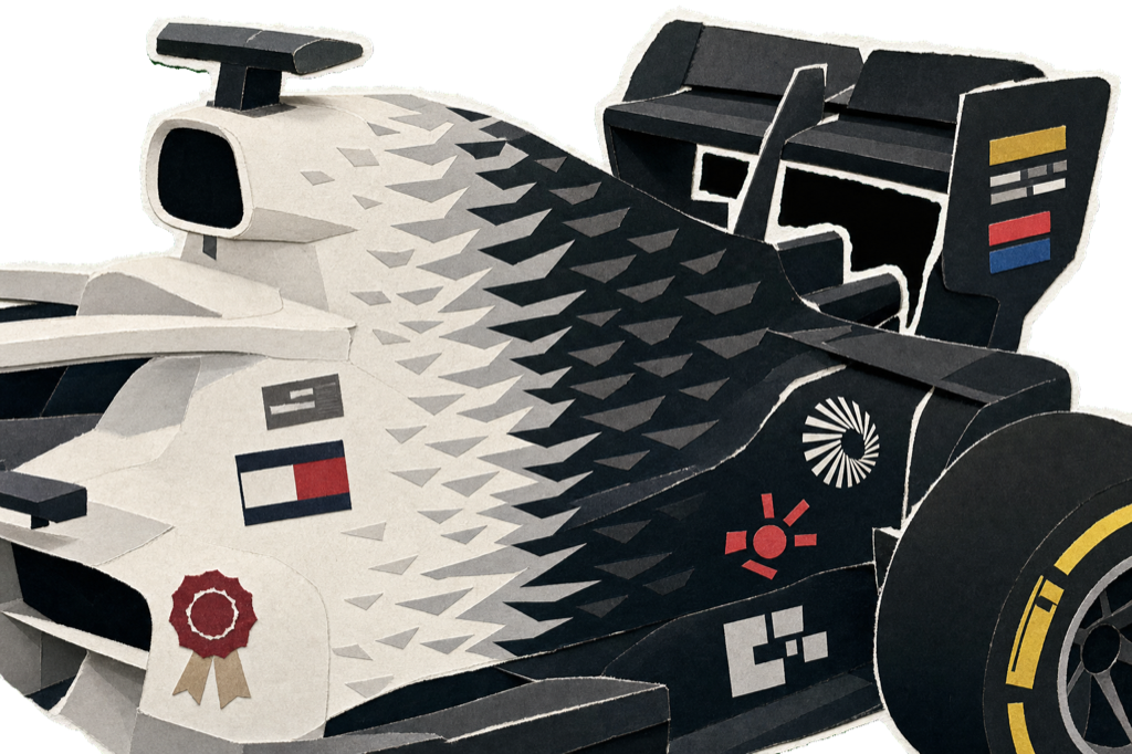 The MAC-26's signature split livery: greyish-white on the left, black on the right, fused by a feathered gradient of repeating Cadillac chevrons that fakes motion at a standstill.